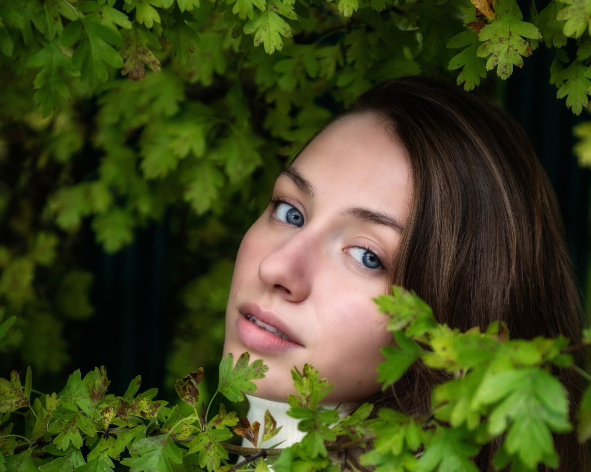 Girl's face surrounded by leaves