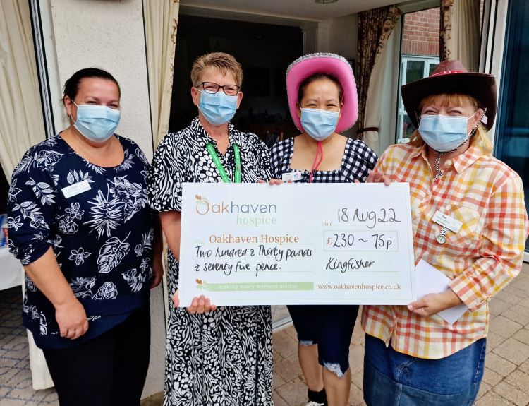 Staff at Colten Care's Kingfishers present a cheque to Oakhaven Hospice for £230.75