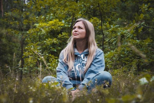 woman cross legged in forest Natural Health Hub