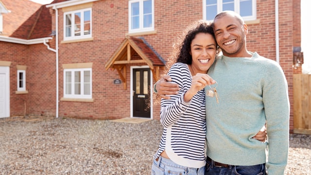 young couple with keys to house