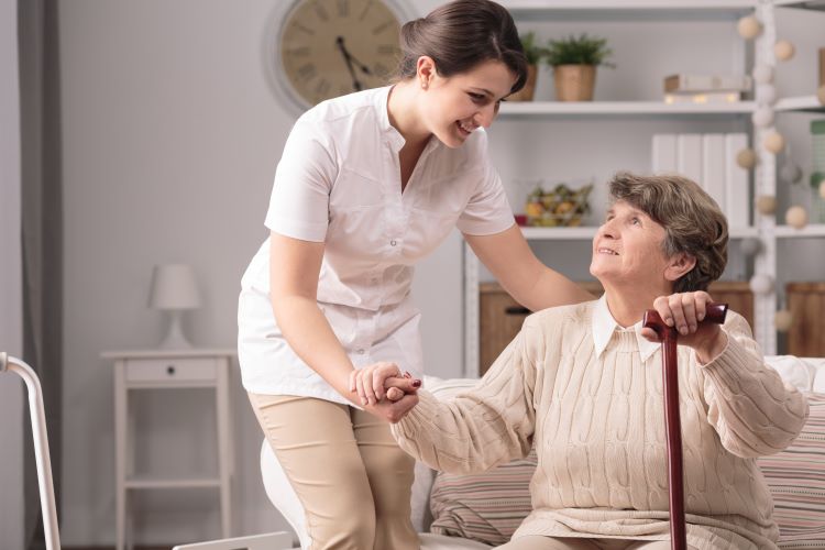 Carer helping elderly patient